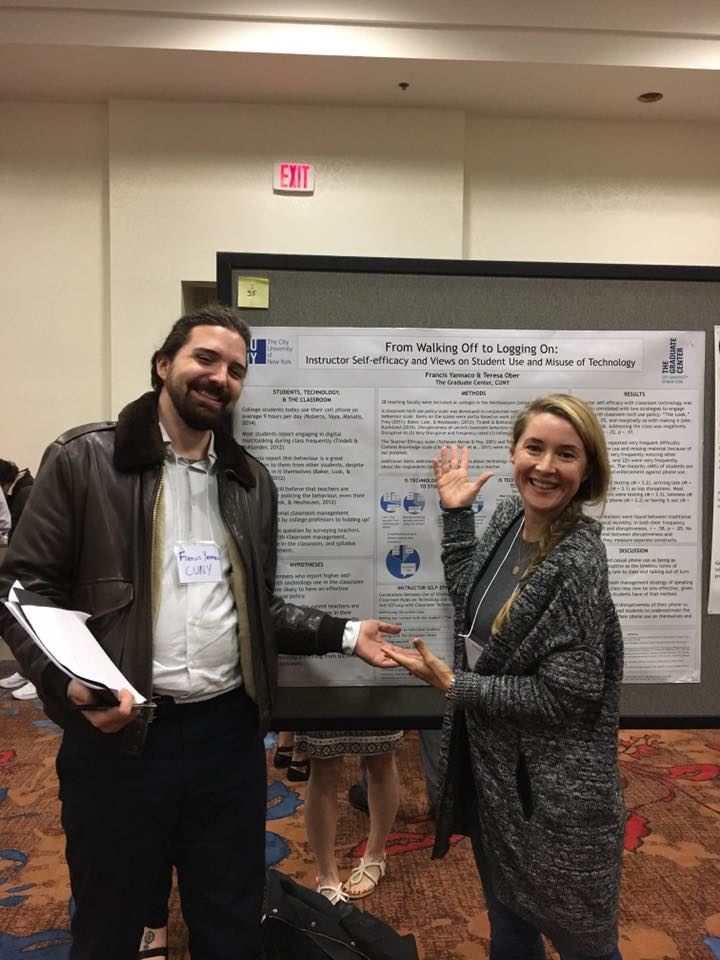 Two people presenting a conference poster